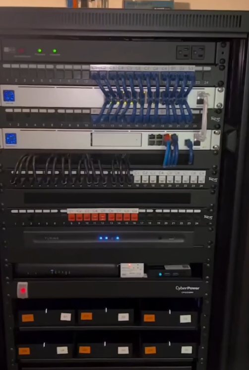 Rack organizado com patch panels, switches, nobreak e caixas identificadas